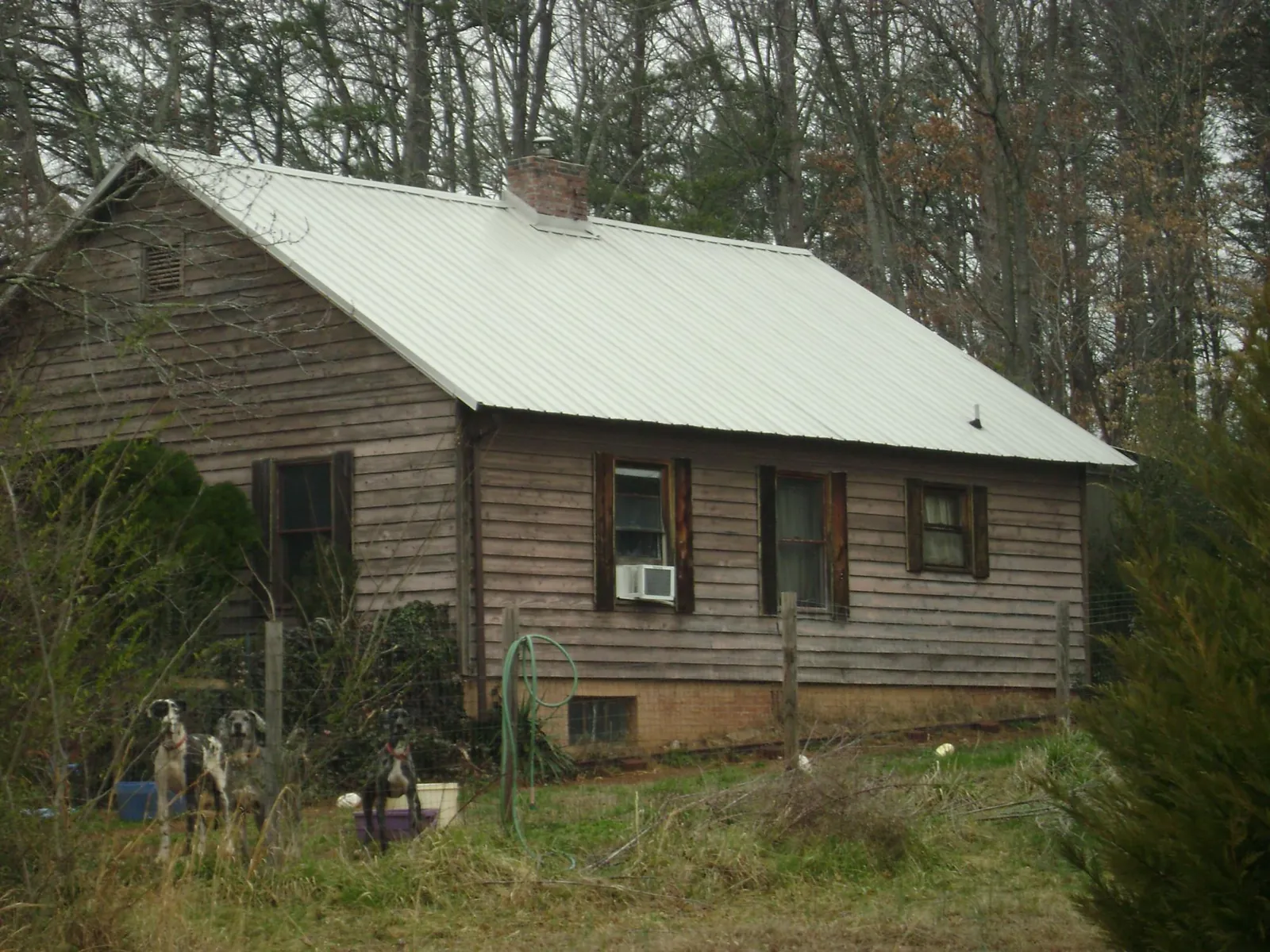 White metal roof on an old wood sided farmhouse, from a Asphalt Shingle Roof Repair job in Orland Park